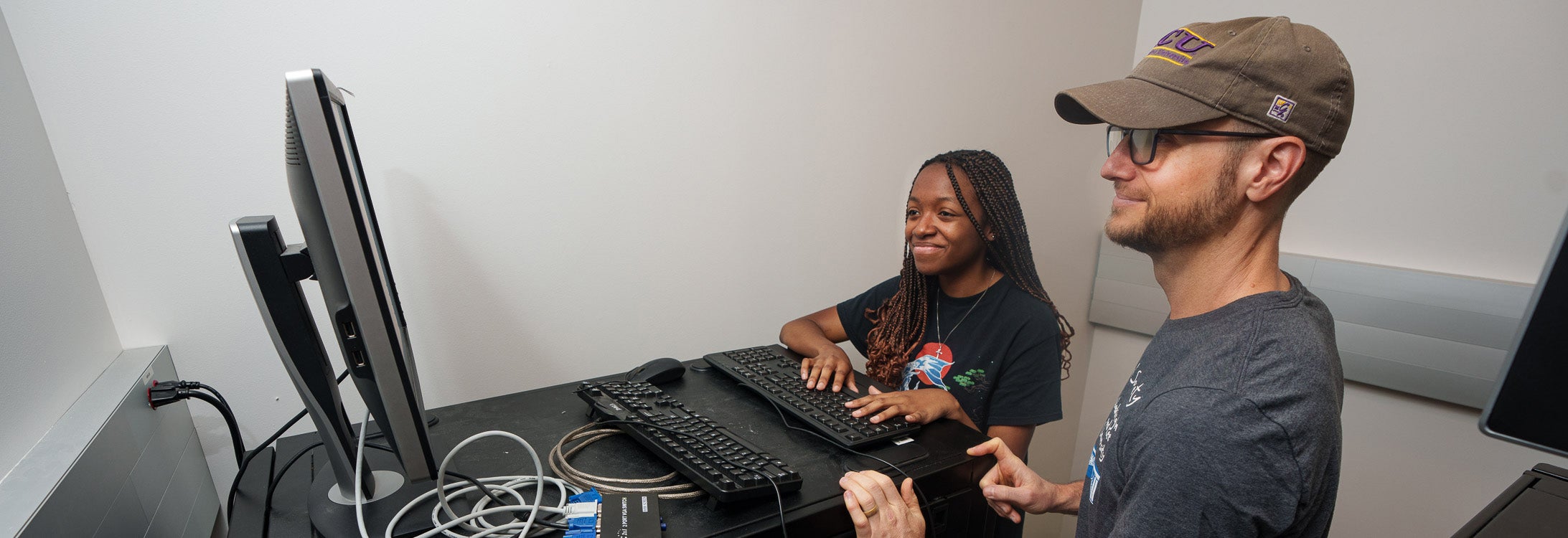 Dr. Michael Brewer and Hannah Pankey examine data pertaining to spider venom protein sequences. Brewer is leading Pankey in the analysis as part of the GlaxoSmithKline Foundation funding for the ECU STEM Summer Immersion program. (ECU photos by Cliff Hollis)