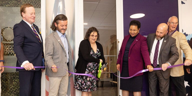 ECU faculty, staff and alumni cut the ribbon to celebrate the new office of ECU’s Military & Veterans Resource Center in the Main Campus Student Center. (Photos by Rhett Butler)