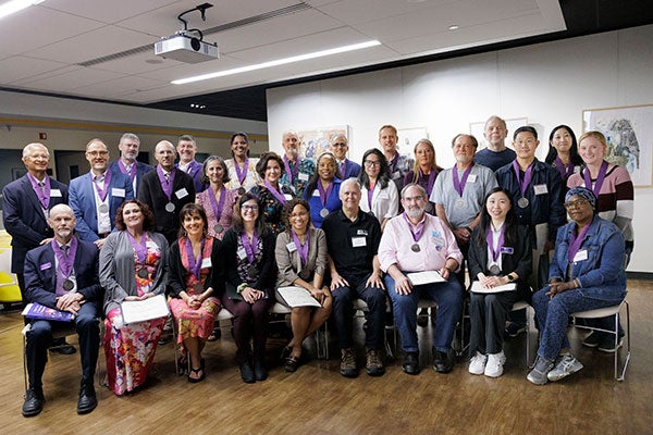 Authors and editors in a group smiling after their awards ceremony.