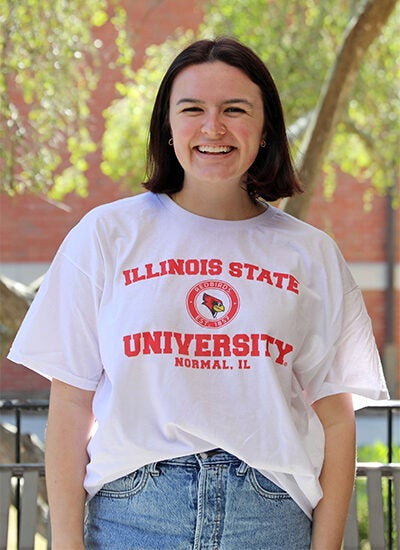 Woman in white t-shirt featuring the logo of Illinois State University