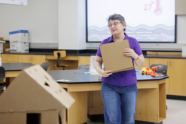 Dr. Carol Massarra, assistant professor in ECU's Department of Construction Management, talks to attendess about how to incorporate cardboard constructed houses into STEM teaching strategies. (Photo by Steven Mantilla)