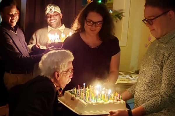 ECU students celebrate Jesse Peel’s 80th birthday at his home in Atlanta.